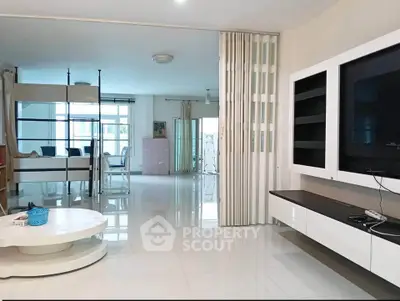 Spacious modern living room with sleek furniture and open layout, perfect for contemporary living.