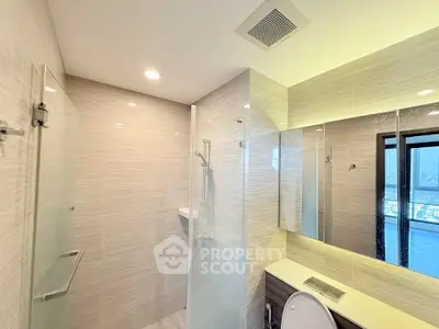 Modern bathroom with glass shower and city view window