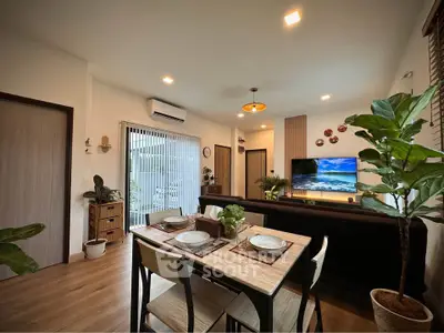 Modern living room with dining area, stylish decor, and natural light