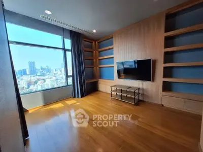 Spacious modern living room with city view and built-in shelves