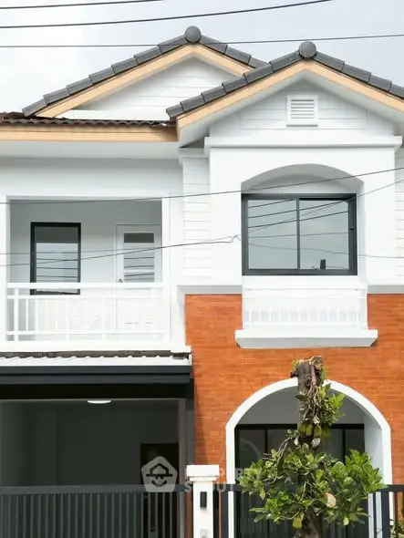 Charming two-story house with modern facade and balcony