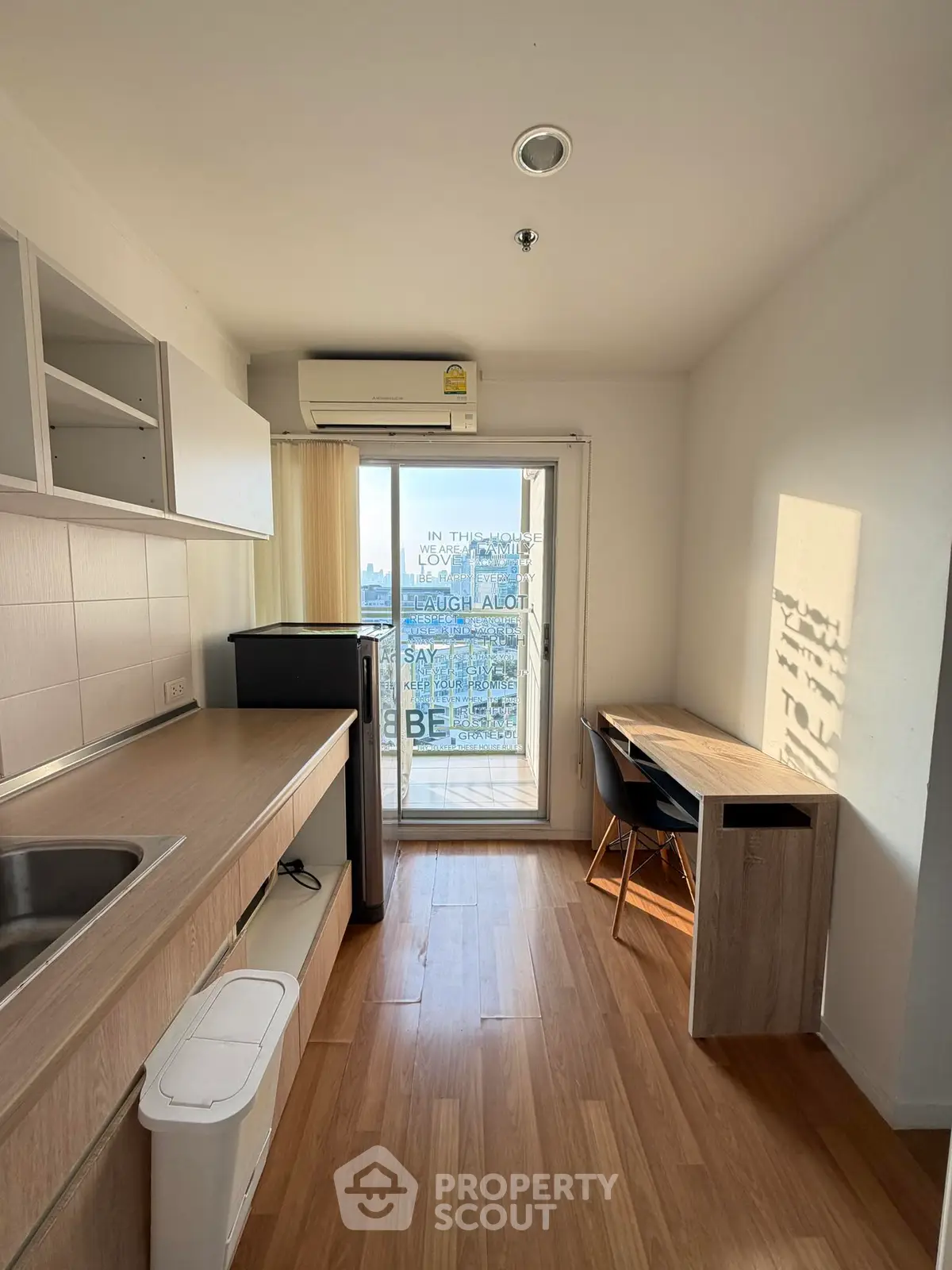 Modern kitchen with sleek design and city view from balcony