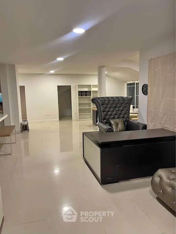 Spacious modern living room with elegant furniture and glossy tiled floors