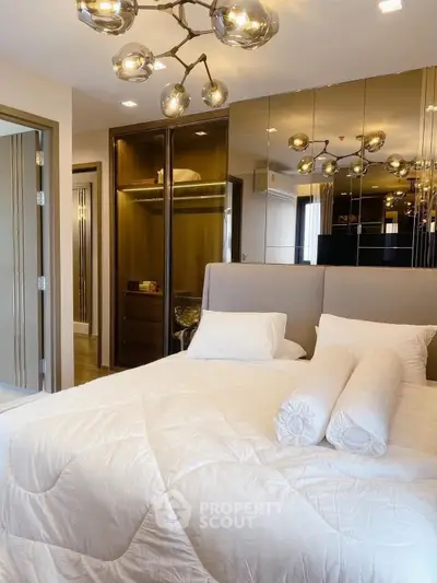 Luxurious bedroom with modern lighting and mirrored wardrobe