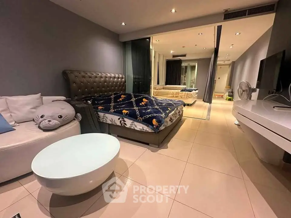 Modern bedroom with stylish decor and cozy seating area