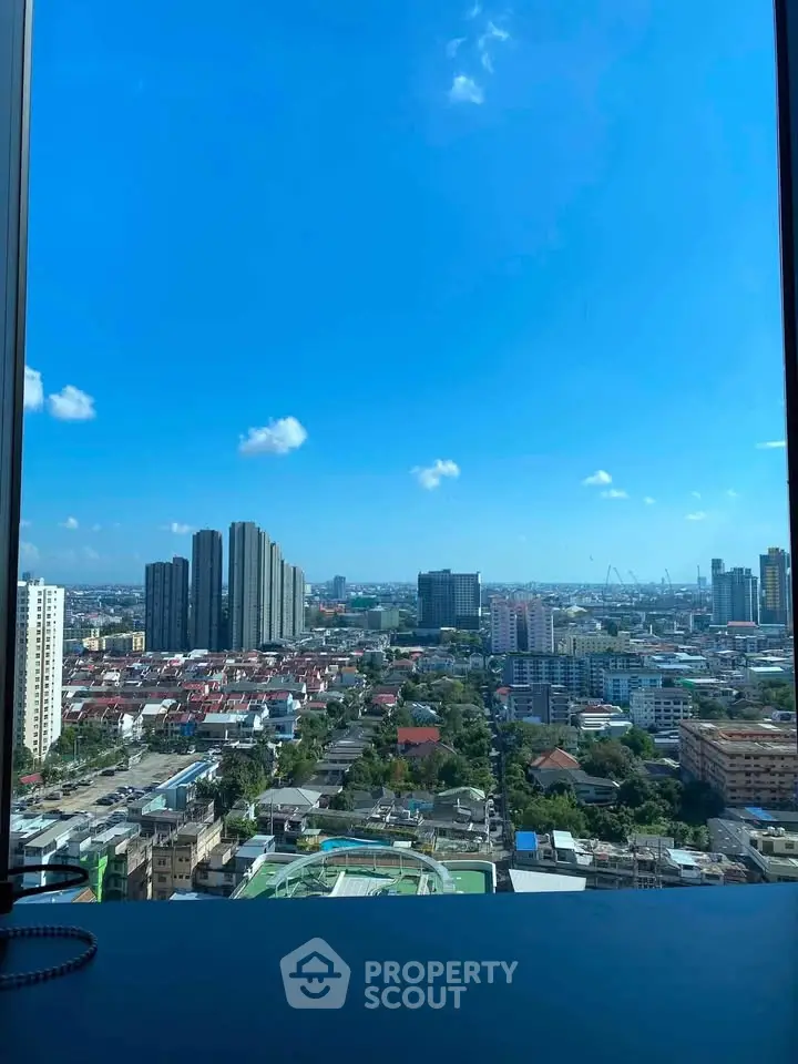 Stunning cityscape view from high-rise building window showcasing urban skyline.