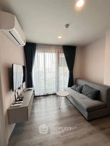 Modern living room with sleek furniture and natural light, perfect for urban living.