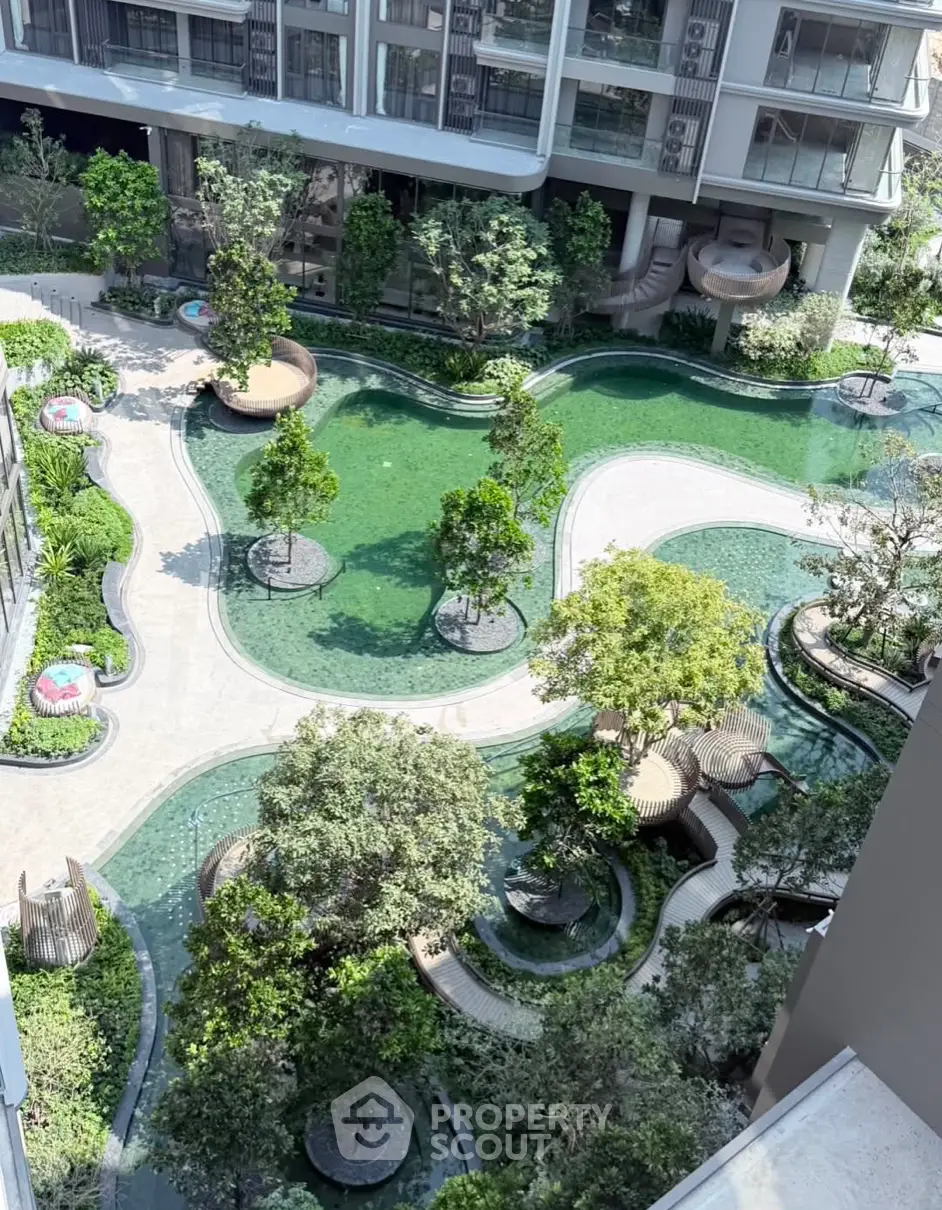 Luxurious residential complex with lush gardens and serene water features