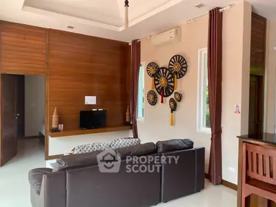 Spacious living room with modern decor and wooden accents in a stylish home.