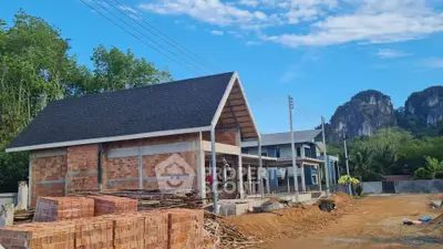 Newly constructed brick house with scenic mountain backdrop
