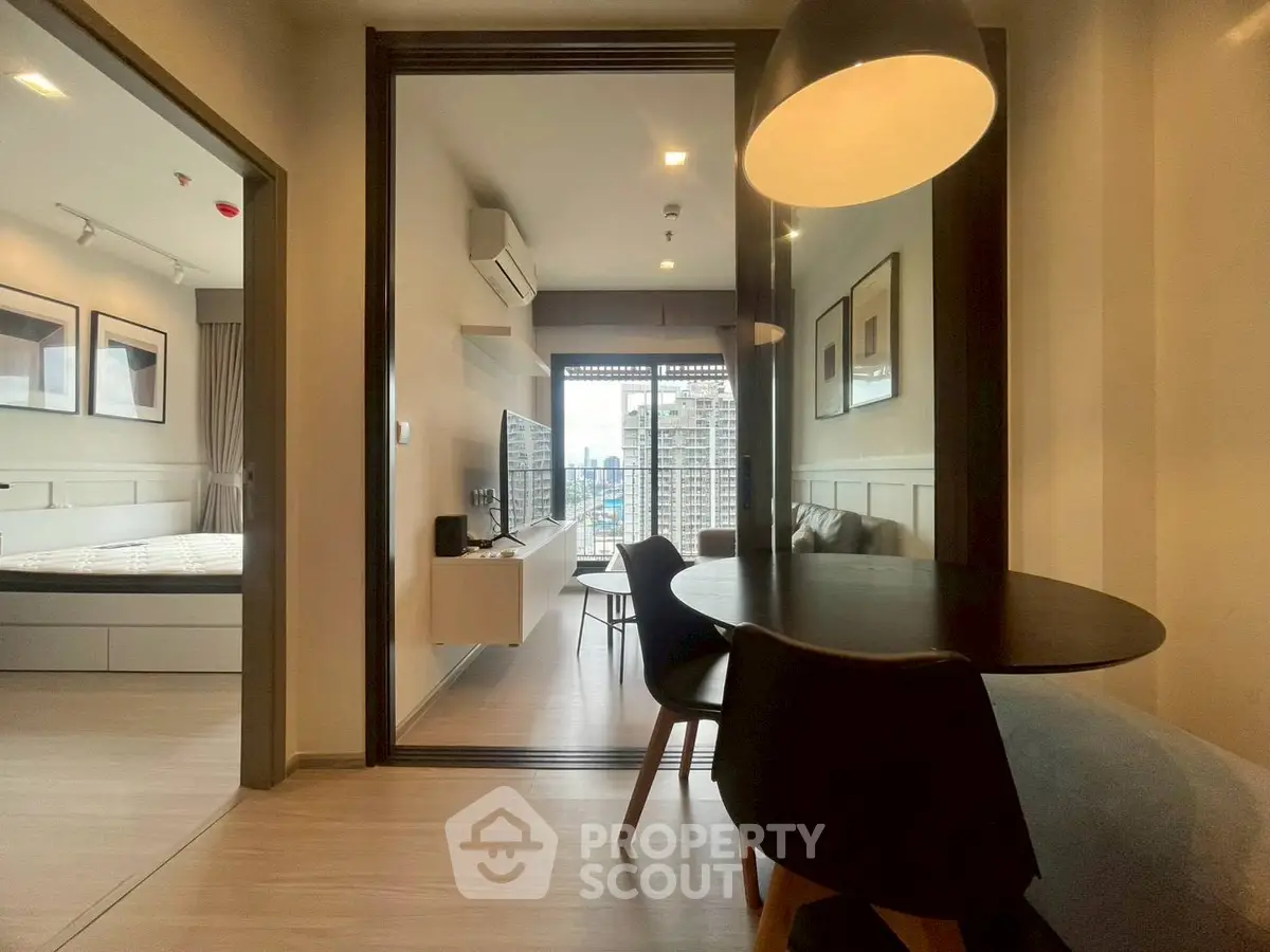 Modern apartment interior with open layout, featuring a cozy living area and stylish dining space.