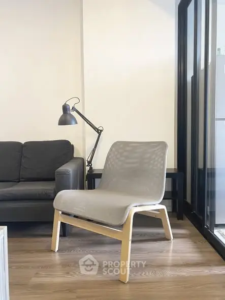 Modern living room with stylish furniture and elegant lighting, featuring a cozy seating area and sleek wooden flooring.