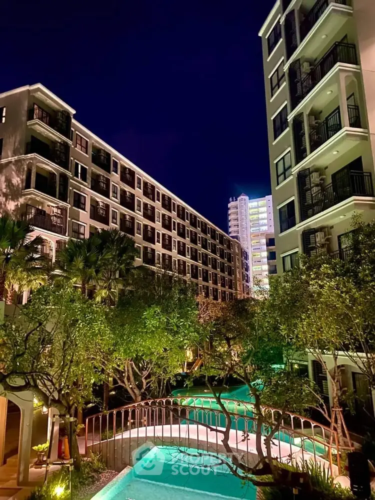 Luxurious apartment complex with lush garden and inviting pool under a starry night sky, offering a serene urban oasis.