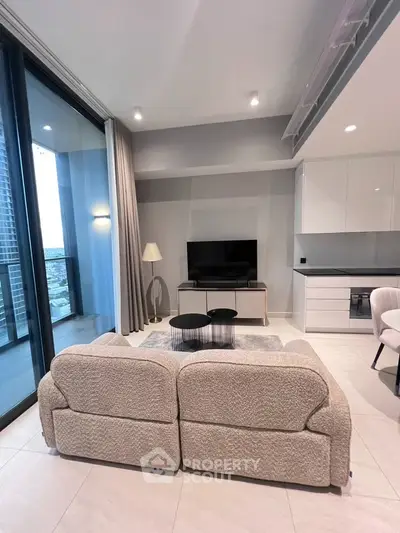 Modern living room with cozy sofa and city view balcony in luxury apartment.