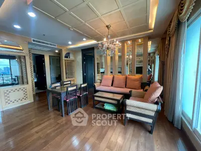 Luxurious living room with elegant chandelier and hardwood floors in high-rise apartment