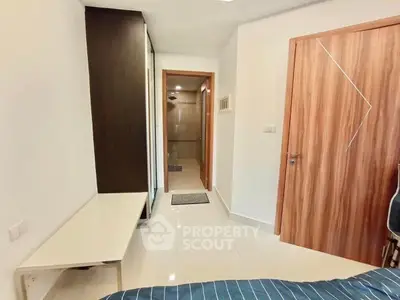 Modern bedroom with sleek design and wooden accents