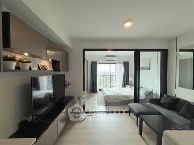 Modern open-plan living room with sleek furniture and large windows offering a stunning view.