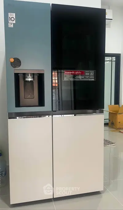 Modern kitchen with sleek refrigerator and glossy floor tiles