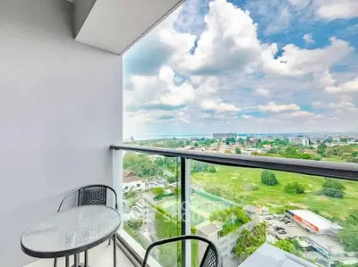 Stunning balcony with panoramic view of lush greenery and cityscape, perfect for relaxation.
