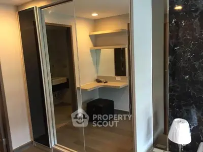 Modern bedroom with mirrored wardrobe and stylish vanity area