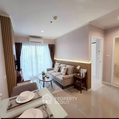 Modern living room with elegant decor and natural light in a stylish apartment.