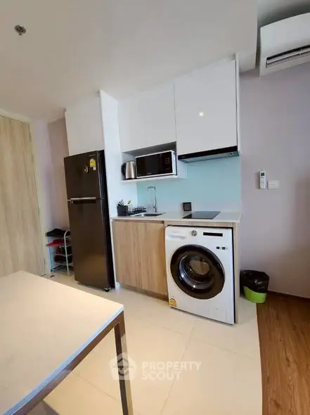 Modern compact kitchen with washing machine and sleek appliances