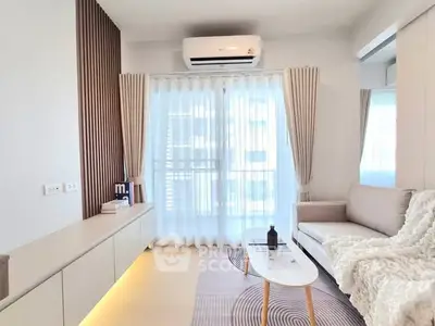 Bright modern living room with cozy sofa, stylish decor, and large window for natural light.