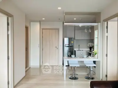 Modern open-plan kitchen and dining area with sleek design and natural light.