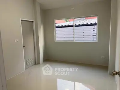 Bright empty room with large window and glossy tiled floor, perfect for customization.