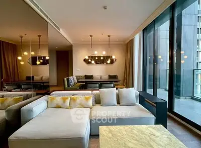 Luxurious living room with modern decor and floor-to-ceiling windows in a high-rise apartment.