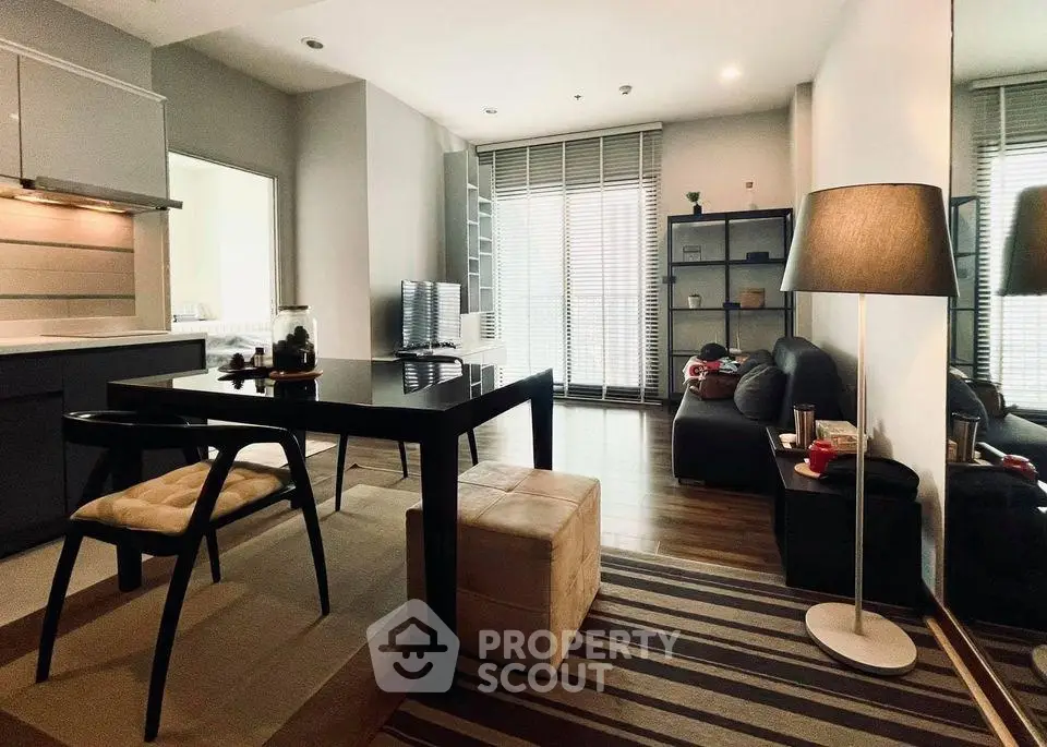 Modern living room with sleek furniture and large windows in a stylish apartment.