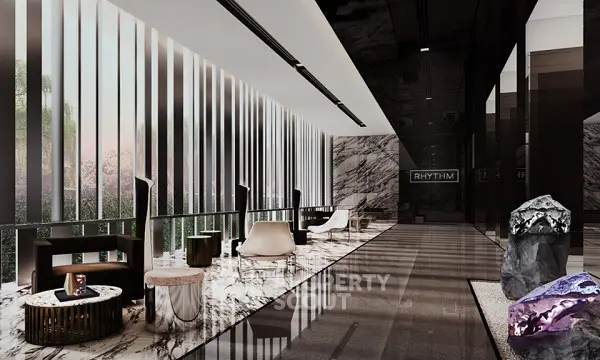 Luxurious modern lobby with marble floors and stylish seating in upscale building.
