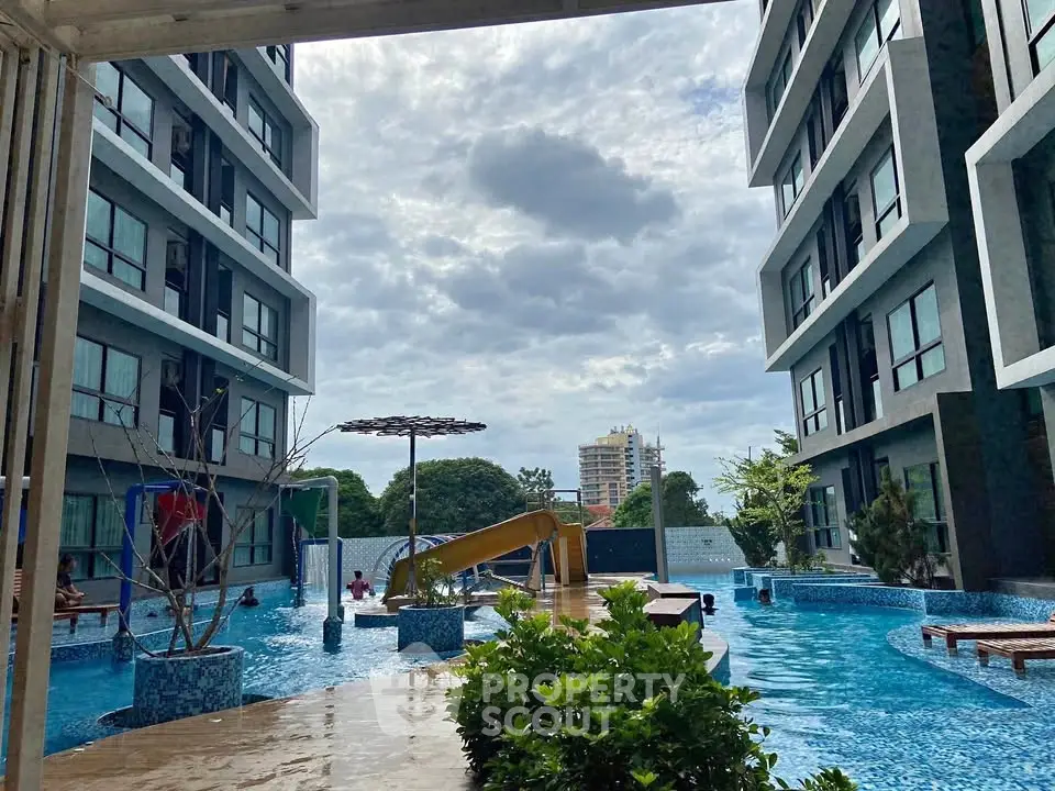 Modern apartment complex with a stunning pool and slide, perfect for family living.