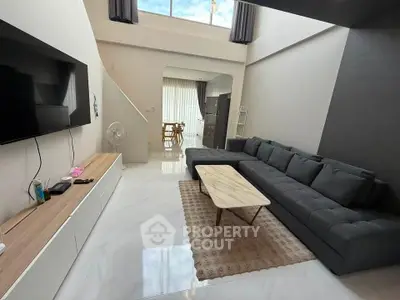 Spacious modern living room with high ceiling and stylish furniture