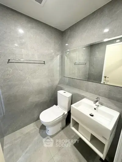 Modern bathroom with sleek gray tiles and contemporary fixtures