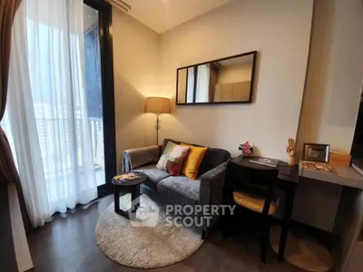 Cozy living room with modern decor and balcony access in stylish apartment.
