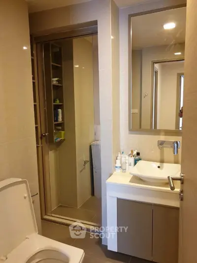 Modern bathroom with sleek fixtures and glass shower enclosure