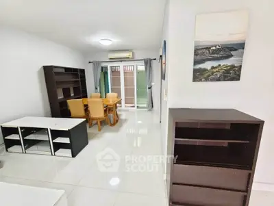 Spacious living room with modern furniture and natural light in a stylish apartment.