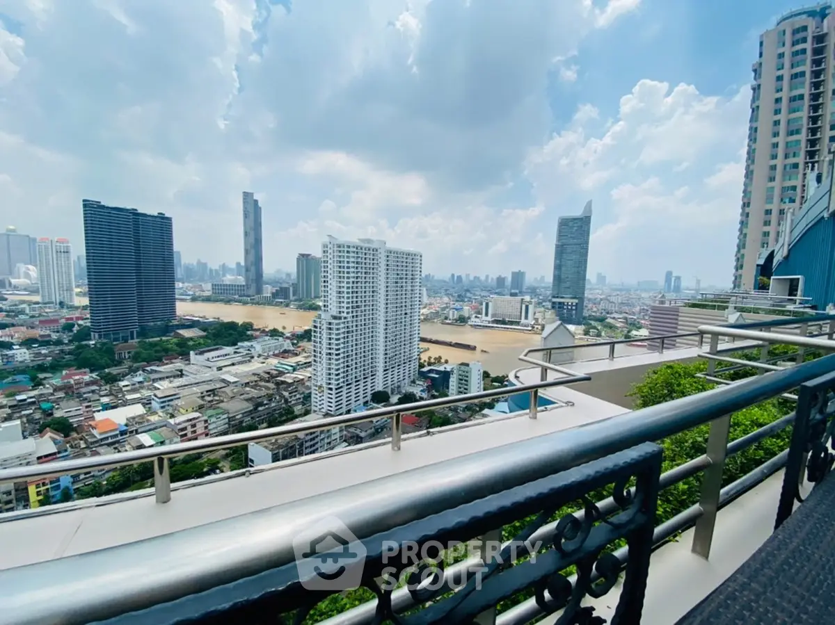 Stunning cityscape view from a high-rise balcony overlooking the river and skyline.