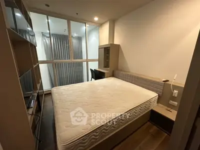 Modern bedroom with sleek design and ample storage in a contemporary apartment.