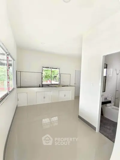 Spacious kitchen with sleek countertops and large windows for natural light