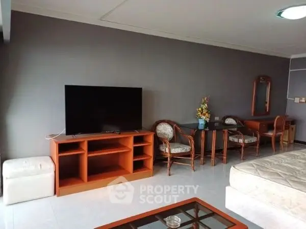Spacious living room with modern TV setup and elegant furniture