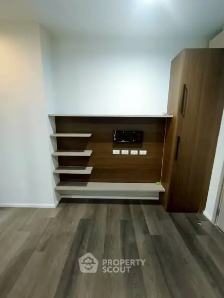Modern living room with sleek wooden shelving and storage unit