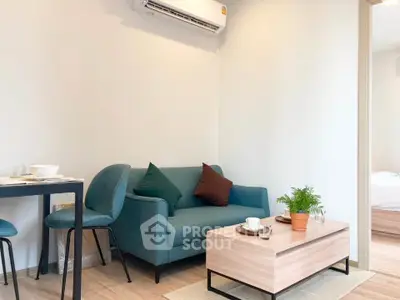 Modern living room with teal sofa, wooden coffee table, and air conditioning unit.