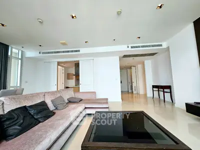 Spacious modern living room with elegant sofa and sleek design in luxury apartment.