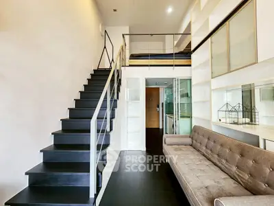 Modern loft apartment with mezzanine bedroom and sleek staircase