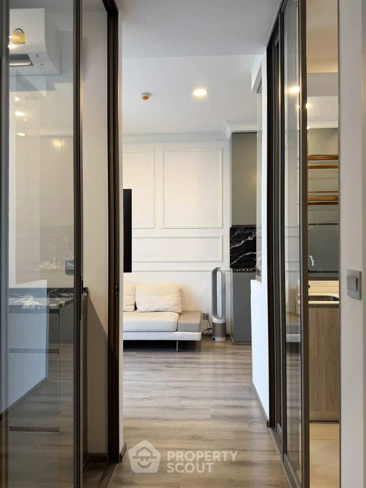 Modern apartment hallway with sleek design and cozy living area