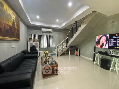 Modern living room with sleek staircase and stylish decor