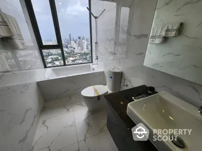 Luxurious bathroom with city view, featuring modern fixtures and elegant marble design.