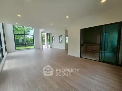 Spacious modern living room with large windows and garden view